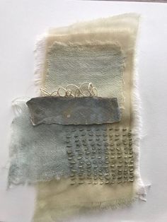 a piece of fabric with different colors on it and some metal pieces in the middle