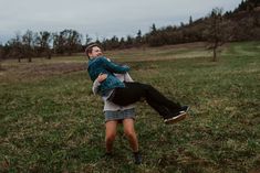 a man carrying a woman on his back in a field