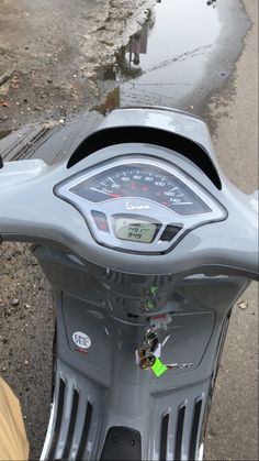 a close up view of the speedometer on a motor scooter's handlebars