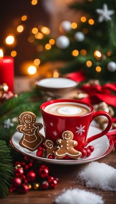 a cup of coffee on a saucer decorated with gingerbreads and christmas decorations