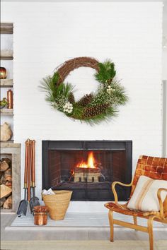 a living room with a fire place and wreath on the wall