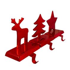 a red metal object with trees and deers on it's back end, sitting on a white surface