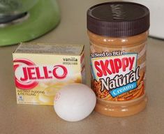 a jar of jello next to an egg on a counter with a carton of yogurt