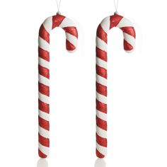 two christmas candy canes hanging from strings