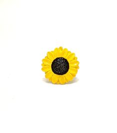 Introducing Naomi's Luxe Sunflower Ring, the perfect accessory to brighten up any outfit! This stunning ring features a beautiful sunflower design with a chic black center, adding a touch of whimsy to your look. Whether you're looking to treat yourself or surprise a loved one, this ring is sure to put a smile on anyone's face. Made for those who appreciate a dash of sunshine in their lives, Naomi's Luxe Sunflower Ring is a must-have for any fashionista. So why wait? Grab yours today and let your style bloom! Metal: Lead-free Pewter. Weight: 10g Sunflower Design Rings Suitable For Gifts, Adjustable Sunflower Design Flower Ring Gift, Sunflower Design Rings As Gifts, Silver Sunflower Design Ring, Yellow Flower-shaped Jewelry With Sunflower Print, Beacon Ny, Sunflower Ring, Sunflower Design, Rings Statement