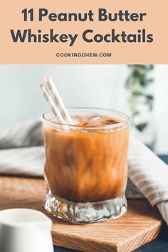 a glass filled with ice and cinnamon sitting on top of a wooden cutting board next to a