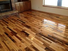 an empty living room with wood floors and a fireplace