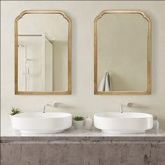 two sinks with mirrors above them in a bathroom