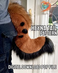 a person holding a stuffed animal in front of a door with the words heya tail pattern on it