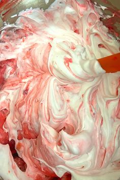 a bowl filled with red and white whipped cream