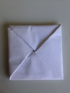 an origami piece is folded into a square