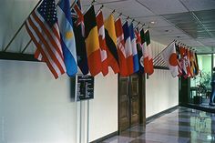 flags hanging from the ceiling in an office building