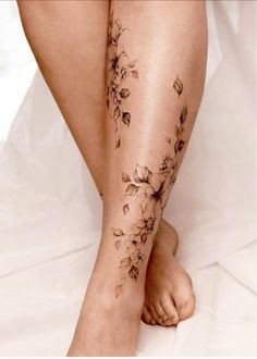 a woman's legs with flowers on them