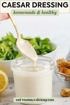 a person pouring dressing into a glass jar