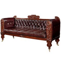 a brown leather couch sitting on top of a wooden table