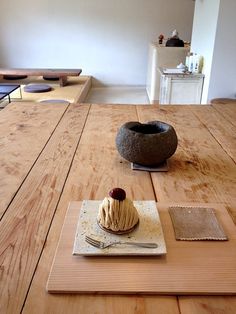 a wooden table topped with a cake on top of a plate