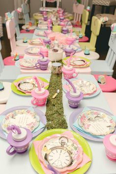 a table set up with plates, cups and utensils for children's birthday party