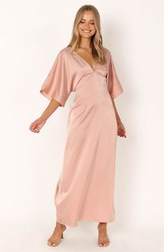 Drapey dolman sleeves frame a smooth satin maxi dress fashioned with a gracefully dipped back and attached waist ties. Slips on over head Deep V-neck Elbow-length sleeves Attached waist ties Unlined 100% polyester Hand wash, dry flat Imported Dolman Sleeve Maxi Dress, Satin Dresses Long, Petal And Pup, Eliza Dress, Essential Dress, Resort Dresses, Usa Dresses, Satin Maxi Dress, Dresses By Length