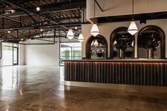 the inside of an empty building with lights hanging from the ceiling