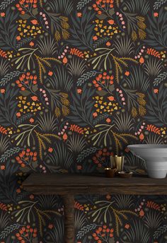 the wallpaper in this room is decorated with colorful flowers and leaves, along with a bowl