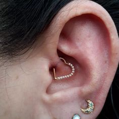 an ear with two piercings attached to it