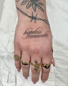 a person with tattoos on their hands and fingers