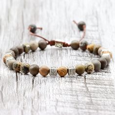 ◈ This beautiful Tibetan bracelet is carefully handcrafted with jasper rhodonite beads and high quality wooden beads. Each bead has been individually selected to ensure beauty and durability. This handcrafted men's bracelet is a versatile accessory that can complement any outfit. The wooden beads used in this bracelet have a rustic, natural charm. Each has a unique pattern and texture, making each bracelet a special and unique piece. These beads are strung on sturdy thread that has been skillful Adjustable Jasper Jewelry For Healing, Healing Jasper Bracelets With 8mm Beads, Spiritual Jasper Bracelets With 8mm Beads, Spiritual Jasper Bracelets With Gemstone Beads, Spiritual Jasper Gemstone Beads Bracelets, Spiritual Jasper Bracelet With 8mm Beads, Jasper Bracelets For Healing With Round Beads, Adjustable Earthy Jasper Jewelry, Earthy Adjustable Jasper Jewelry