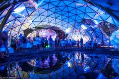 the inside of a dome with people standing around it