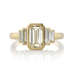 1.50ct N/VS2 GIA certified Emerald cut diamond with 0.50ctw Baguette cut accent diamonds set in a handcrafted 18K yellow gold mounting. Ring is currently a size 6 and can be sized to fit. Stone Certificate 1.50ct N/VS2 Gia Certified Rectangular Yellow Gold Diamond Ring, Gia Certified Gold Baguette Cut Diamond Ring, Gia Certified Rectangular Gold Diamond Ring, Luxury Diamond Ring With Baguette Cut And Bezel Setting, Gold Radiant Cut Diamond Ring With Baguette Diamonds, Gold Radiant Cut Diamond Ring With Baguettes, Luxury Baguette Cut Diamond Ring With Bezel Setting, Gold Asscher Cut Diamond Ring With Baguette Diamonds, Asscher Cut Gold Diamond Ring With Baguette Diamonds