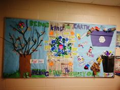 the bulletin board is decorated with colorful pictures and writing on it, along with a tree