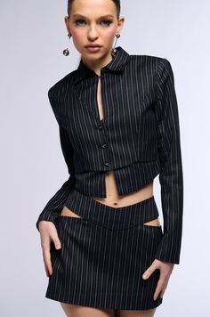 From bar to business, or whatever you have on the social calendar. The Sabrina Pinstripe Cut Out Mini Skirt features a woven, non-stretch base, classic pinstripe patterning, a high rise design with side cut outs at the hips, and a mini length silhouette. Complete with soft polyester inner lining, and a tonal back zipper closure. Rock it with pumps and the coordinating AKIRA Label Sabrina Pinstripe Button Down Blouse.  - Shell: 65% Polyester 33% Rayon 2% Spandex, Lining: 100% Polyester - No Stretch - Imported (all measurements are approximate from size small) - 13.75” Waist to Hem  - Model is 5’10.5” Product ID: 393771 (all measurements are approximate from size 1X) - 16.75” Waist to Hem Product ID: 393775 Business Baddie, Sandal Boots, Social Calendar, Side Cuts, Woven Top, Open Toe Sandals, Button Down Blouse, Cut Outs, Button Downs