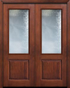 a wooden double door with frosted glass