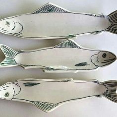 three fish shaped dishes sitting next to each other