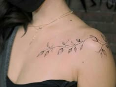 a woman with a tattoo on her shoulder