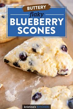 blueberry scones on a baking sheet with text overlay that reads, buttery flaky blueberry scones