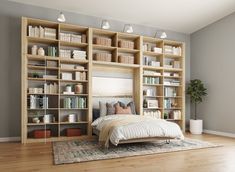 a bed sitting in front of a book shelf filled with books on top of a hard wood floor