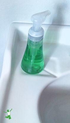 a bottle of hand sanitizer sitting on top of a sink