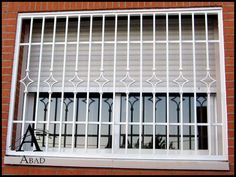 a white window with bars on the outside