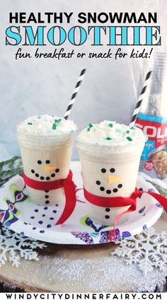 two cups with whipped cream and sprinkles on them sitting on a plate