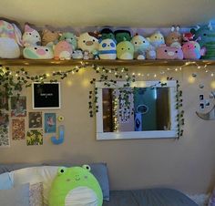 there are many stuffed animals on the shelf above the bed