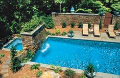 an aerial view of a backyard with a swimming pool and lounge chairs in the foreground