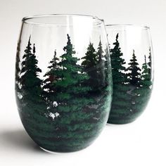 two wine glasses with trees painted on them