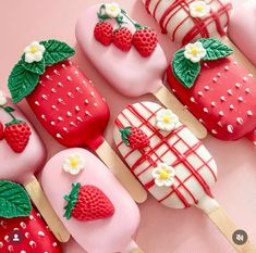 strawberry shortcakes on sticks decorated with fondant and strawberries are ready to be eaten