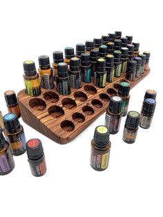 an assortment of essential oils on a wooden tray