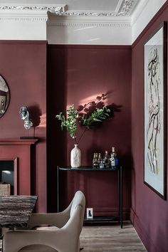 a living room filled with furniture and a fire place next to a wall mounted clock