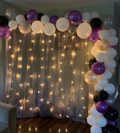 a room with balloons and lights on the wall