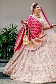 a woman in a pink and red bridal gown