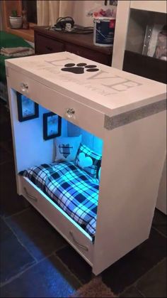 a bed made out of a cabinet with lights on it's sides and the door open