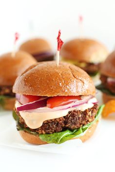 several hamburgers with toothpicks stuck in them