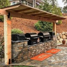 an outdoor bbq with grills and seating area